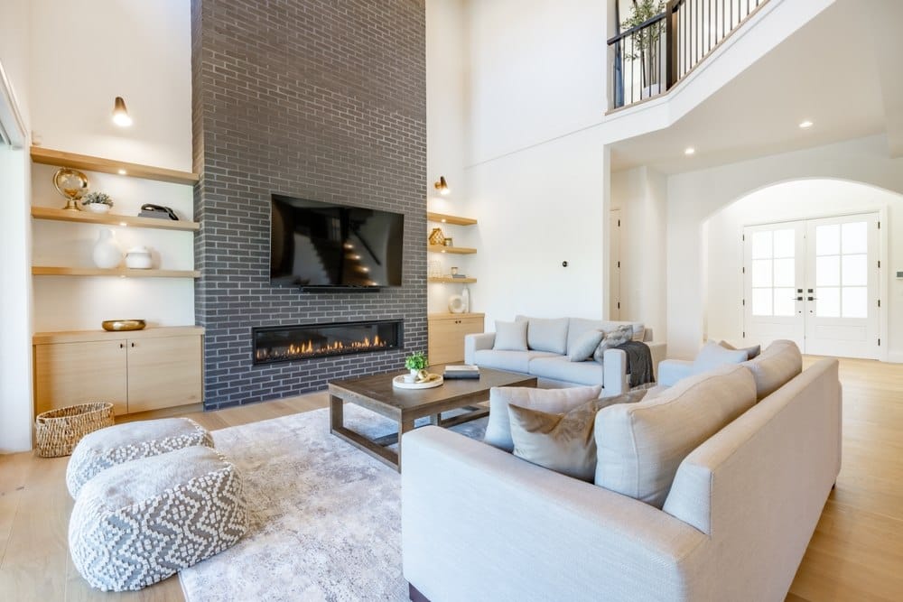 living room with dark tile accent wall behind fireplace Sheila Say/Shutterstock