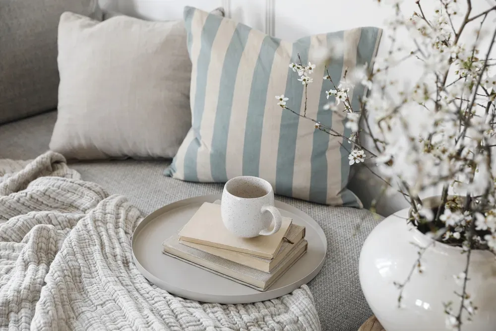 light blue and white striped pillow with blankets and decor